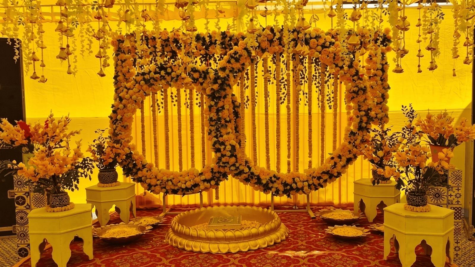 Marigold garland haldi backdrop with hanging strings and low seating in Jaipur by Shava Moments